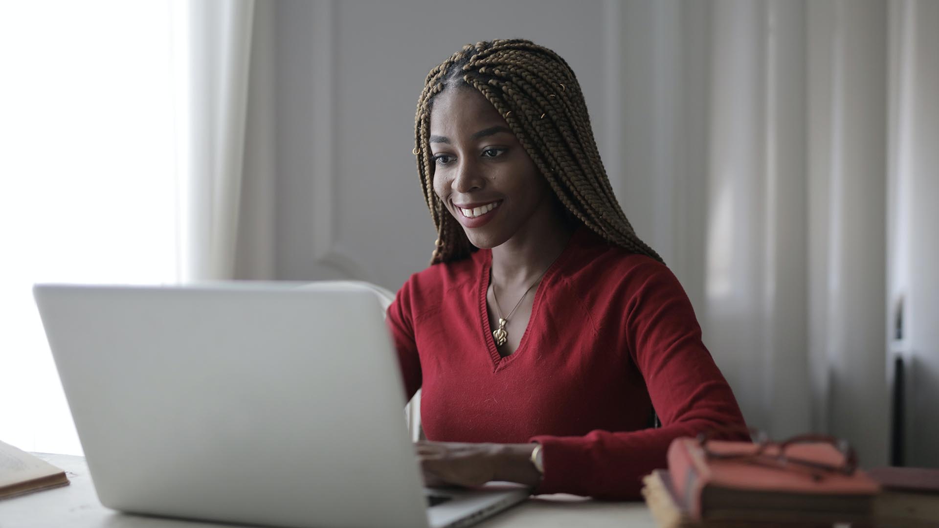 Photo of a black woman using a laptop