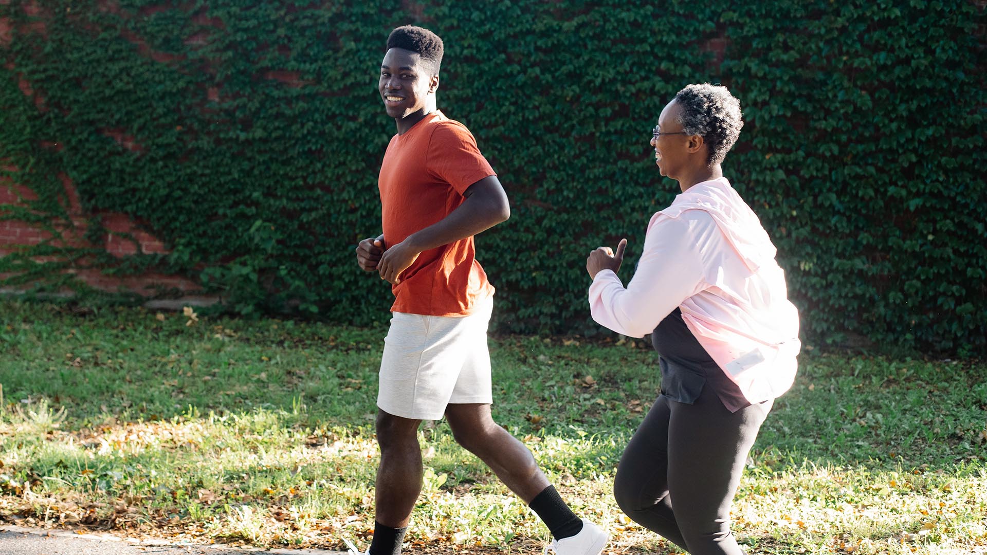 Photo of a black man and older black woman jogging