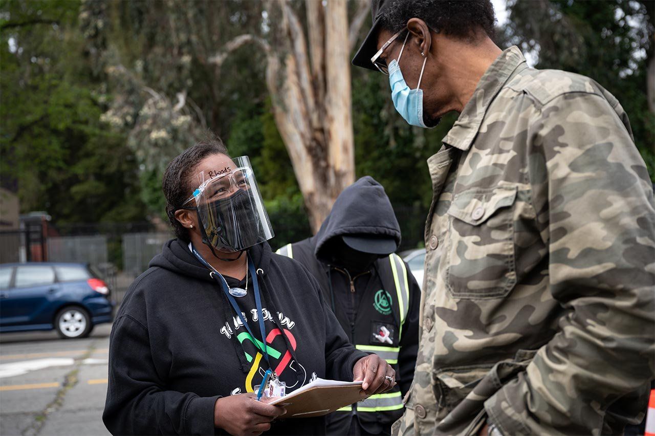 Dr. Kim Rhoads talking to a person in the community