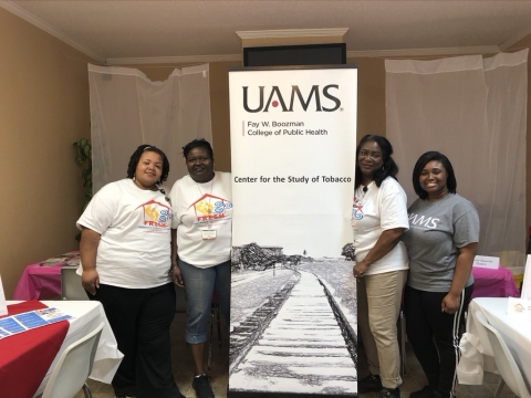Photo of four women with UAMS banner