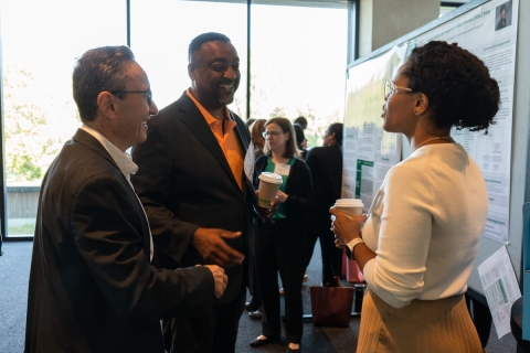 Attendees at a poster session